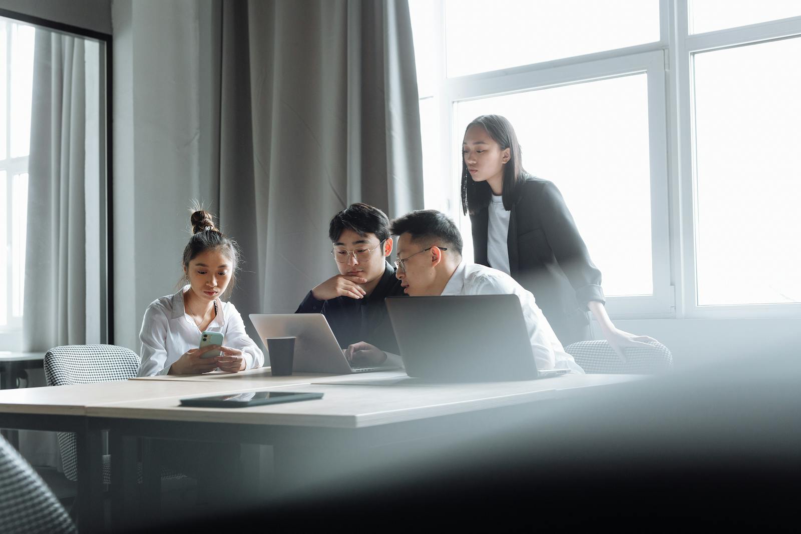Startup team collaborating around a laptop in an office